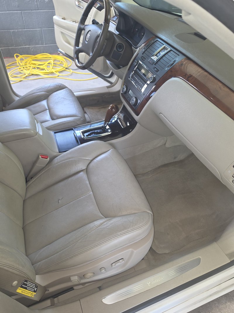 Front seats and console of a high-mileage sedan after an interior detail, Hartford WI